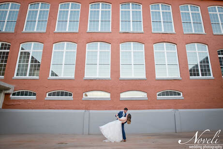 A groom shares a dance with his bride in the courtyard of Judson Mill